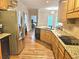 Spacious kitchen featuring granite countertops, stainless steel appliances, and hardwood floors at 4855 West Price Rd, Sugar Hill, GA 30518