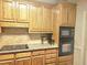 Close-up of kitchen featuring granite countertops, tile backsplash, and modern appliances at 4855 West Price Rd, Sugar Hill, GA 30518
