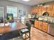 Traditional kitchen features wooden cabinets, granite countertops, and stainless steel appliances at 4855 West Price Rd, Sugar Hill, GA 30518