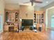 Spacious living room with wood floors, built-in shelving, brick fireplace, and large windows at 4855 West Price Rd, Sugar Hill, GA 30518