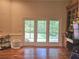 Bright and airy living room featuring hardwood floors, French doors, and natural light at 4855 West Price Rd, Sugar Hill, GA 30518
