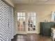 An office space with glass french doors, hardwood floors, and natural light at 4855 West Price Rd, Sugar Hill, GA 30518