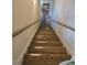 View of a wood staircase with a wooden railing leading up to the upper level at 4855 West Price Rd, Sugar Hill, GA 30518