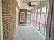 Enclosed sunroom features brick walls, a ceiling fan and floor to ceiling windows at 4855 West Price Rd, Sugar Hill, GA 30518