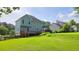Spacious backyard with a well-maintained lawn and a wooden deck, perfect for outdoor entertaining at 4905 Puritan Dr, Sugar Hill, GA 30518