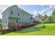 Expansive backyard featuring a wooden deck, ideal for relaxation and gatherings, with a lush lawn at 4905 Puritan Dr, Sugar Hill, GA 30518