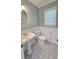 Cozy bathroom featuring neutral paint, tile floors, and single sink vanity at 4905 Puritan Dr, Sugar Hill, GA 30518