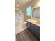 Bright bathroom featuring a wide vanity and a shower with a floral curtain at 4905 Puritan Dr, Sugar Hill, GA 30518