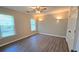 Bedroom with hardwood floors, neutral walls, and recessed lights at 4905 Puritan Dr, Sugar Hill, GA 30518