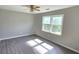 Bright bedroom features ceiling fan, hardwood floors, and bright natural light at 4905 Puritan Dr, Sugar Hill, GA 30518