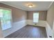 Spacious bedroom with neutral paint, modern floors, and bright natural light at 4905 Puritan Dr, Sugar Hill, GA 30518