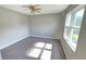 Bright bedroom features ceiling fan, hardwood floors, and bright natural light at 4905 Puritan Dr, Sugar Hill, GA 30518