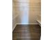Walk-in closet with vinyl wood flooring and multiple shelves for optimal organization at 4905 Puritan Dr, Sugar Hill, GA 30518