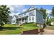 Two-story home with a welcoming front porch and manicured lawn in a lovely neighborhood setting at 4905 Puritan Dr, Sugar Hill, GA 30518