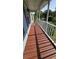 Inviting front porch with wood flooring and white railings, offering a cozy and welcoming entrance at 4905 Puritan Dr, Sugar Hill, GA 30518