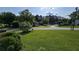 Expansive front yard featuring green lawns and mature trees, offering a serene neighborhood view at 4905 Puritan Dr, Sugar Hill, GA 30518