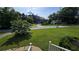 Large front yard featuring a well-manicured lawn and a view of the peaceful street and neighborhood at 4905 Puritan Dr, Sugar Hill, GA 30518