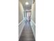 Long hallway with neutral walls and trim, hardwood floors, and recessed lighting at 4905 Puritan Dr, Sugar Hill, GA 30518