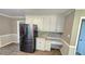 Kitchen featuring stainless steel refrigerator and countertops with bright cabinets at 4905 Puritan Dr, Sugar Hill, GA 30518