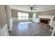 Bright living room featuring a brick fireplace and hardwood flooring at 4905 Puritan Dr, Sugar Hill, GA 30518