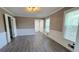 Well-lit living room with hardwood floors, white trim, and large windows at 4905 Puritan Dr, Sugar Hill, GA 30518