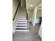 Staircase features wood treads and white risers, with a stained wood handrail at 4905 Puritan Dr, Sugar Hill, GA 30518
