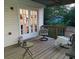 Cozy covered back porch with seating and French doors leading inside at 6070 Ridge Way, Douglasville, GA 30135