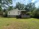 Large backyard featuring an expansive lawn and a wooden deck at 6070 Ridge Way, Douglasville, GA 30135