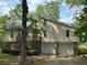 Charming exterior elevation with stone accents, two-car garage, and a wooden deck at 6070 Ridge Way, Douglasville, GA 30135