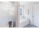 Clean bathroom with a glass-door shower, soaking tub with tile surround, and patterned tile flooring at 1048 Shadow Glen Dr, Fairburn, GA 30213