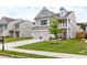 Charming two-story home featuring a two-car garage, a balcony, and a well-manicured lawn at 1048 Shadow Glen Dr, Fairburn, GA 30213