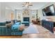 Cozy living room showcasing a fireplace, a large TV, and elegant decor at 1048 Shadow Glen Dr, Fairburn, GA 30213