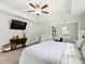 Bright main bedroom features a TV, ceiling fan, carpet flooring and a large window at 1048 Shadow Glen Dr, Fairburn, GA 30213