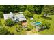 Expansive aerial view of charming home with pool, garden, and outdoor entertainment area amidst lush greenery at 10975 Hutcheson Ferry Rd, Chattahoochee Hills, GA 30268