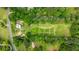 Stunning aerial view of a sprawling property with lush greenery and surrounding trees at 10975 Hutcheson Ferry Rd, Chattahoochee Hills, GA 30268