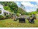 A seating area arranged around a fire pit offers a cozy spot for outdoor relaxation at 10975 Hutcheson Ferry Rd, Chattahoochee Hills, GA 30268