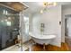 Elegant bathroom featuring a soaking tub, glass shower, and stylish fixtures at 10975 Hutcheson Ferry Rd, Chattahoochee Hills, GA 30268