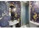 Whimsical powder room with floral wallpaper, unique vanity, and a metal-lined shower at 10975 Hutcheson Ferry Rd, Chattahoochee Hills, GA 30268