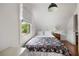 Attic bedroom with a window, wood floors and bedside table at 10975 Hutcheson Ferry Rd, Chattahoochee Hills, GA 30268