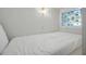 Small attic bedroom features stained glass window at 10975 Hutcheson Ferry Rd, Chattahoochee Hills, GA 30268