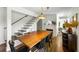 Dining area with a wooden table, traditional decor, and staircase adds to the charm at 10975 Hutcheson Ferry Rd, Chattahoochee Hills, GA 30268