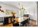 Dining room features a chandelier, wooden table, and a buffet cabinet for elegant entertaining at 10975 Hutcheson Ferry Rd, Chattahoochee Hills, GA 30268