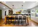 Kitchen features large island with seating, pendant lights, and hardwood flooring at 10975 Hutcheson Ferry Rd, Chattahoochee Hills, GA 30268