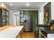 Modern kitchen includes stainless appliances, olive-green cabinets, and a butcher-block island at 10975 Hutcheson Ferry Rd, Chattahoochee Hills, GA 30268