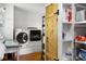 Bright laundry room with washer, dryer, storage and organization at 10975 Hutcheson Ferry Rd, Chattahoochee Hills, GA 30268