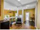 Bright living area showcases mustard-colored walls, natural light, and hardwood floors at 10975 Hutcheson Ferry Rd, Chattahoochee Hills, GA 30268