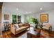 Well-lit living room boasts a fireplace, hardwood floors, and access to the backyard at 10975 Hutcheson Ferry Rd, Chattahoochee Hills, GA 30268