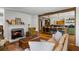 Cozy living room with fireplace opens to a modern kitchen, and features hardwood floors at 10975 Hutcheson Ferry Rd, Chattahoochee Hills, GA 30268