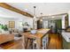 Open-concept living space showcases an expansive island, fireplace, and stainless-steel appliances at 10975 Hutcheson Ferry Rd, Chattahoochee Hills, GA 30268