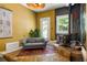 Living room featuring wood burning stove, floral wall art, with adjacent sitting area, and outdoor access at 10975 Hutcheson Ferry Rd, Chattahoochee Hills, GA 30268